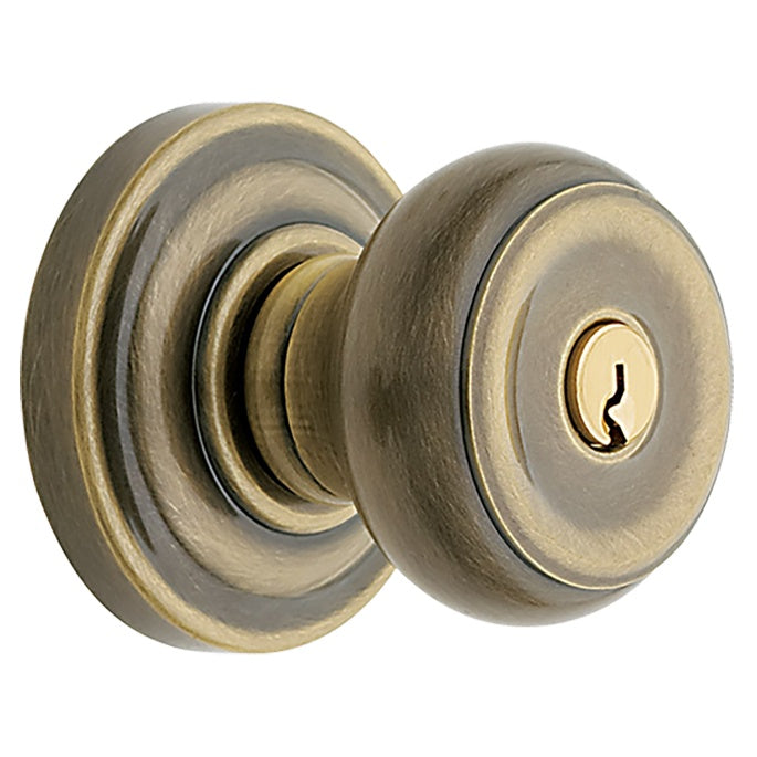 Baldwin Hardware Juego de Entrada con Llave 5210 — Perilla Colonial con Roseta Clásica — Latón antiguo