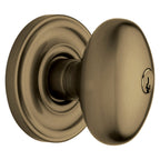 Baldwin Hardware Juego de Entrada con Llave 5225 — Perilla Egg con Roseta Clásica — Latón antiguo